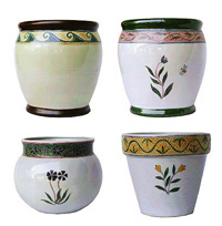A selection of glazed ceramic outdoor pots with a raised mosaic hand painted design