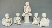 A selection of solid glaze ceramic religious figurines in various colours